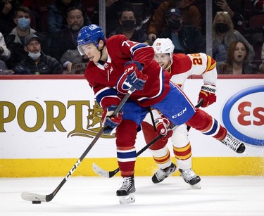 Calgary Flames centreElias Lindholm (28) fails to stop Montreal Canadiens centre Jake Evans (71) from scoring on an empty net in the final minutes during 3rd-period NHL action in Montreal, on Thursday, Nov. 11, 2021.