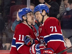 Montreal Canadiens right wing Brendan Gallagher (11) and Montreal Canadiens centre Jake Evans (71) celebrate goal during 3rd-period NHL action against the Calgary Flames in Montreal, on Thursday, Nov. 11, 2021.