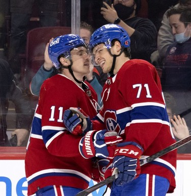 Montreal Canadiens right wing Brendan Gallagher (11) and Montreal Canadiens centre Jake Evans (71) celebrate goal during 3rd-period NHL action against the Calgary Flames in Montreal, on Thursday, Nov. 11, 2021.