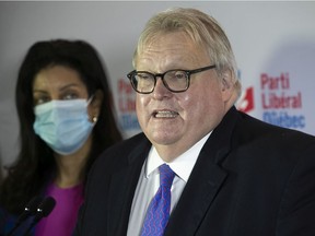 Liberal MNA Gaétan Barrette announces that he will not seek re-election in 2022 at a press conference in Montreal on Sunday, Nov. 14, 2021. Standing next to him is Quebec Liberal Leader Dominique Anglade.
