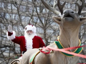 Santa waves to the crowd during the annual Santa Claus parade in Montreal on Nov. 23, 2019.
