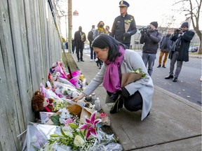 Mayor Valérie Plante and police Chief Sylvain Caron bring flowers to a memorial at the site of the shooting death of 16-year-old Thomas Trudel in St-Michel on Tuesday.