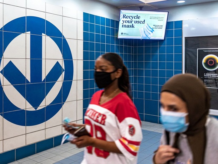  Students are asked to recycle their masks by onscreen reminders at the métro entrance at Dawson College.