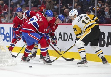 Montreal Canadiens' Cole Caufield, left, Josh Anderson and Christian Dvorak battle for loose puck with Pittsburgh Penguins' Zach Aston-Reese during first period in Montreal Thursday, Nov. 18, 2021.
