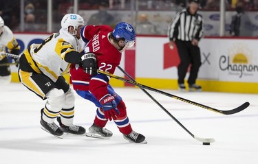 Montreal Canadiens' Cole Caufield holds off Pittsburgh Penguins' Marcus Pettersson during second period in Montreal Thursday, Nov. 18, 2021.