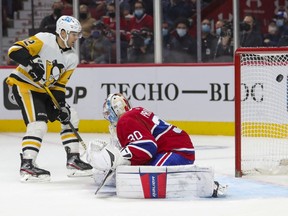 Penguins Zach Aston-Reese watches as the puck flies past Canadiens goalie Cayden Primeau during the second period Thursday night at the Bell Centre.