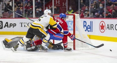 Montreal Canadiens' Brendan Gallagher is shoved off the puck by Pittsburgh Penguins' Michael Matheson next to goalie Tristan Jarry during third period in Montreal Thursday, Nov. 18, 2021.