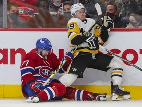 Canadiens' Brett Kulak drags down Penguins' Jake Guentzel during the second period Thursday night at the Bell Centre.
