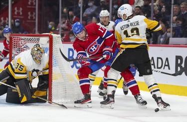 Montreal Canadiens' Josh Anderson fights for puck with Pittsburgh Penguins' Zach Aston-Reese next to goalie Tristan Jarry during first period in Montreal Thursday, Nov. 18, 2021.