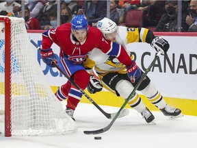 Montreal Canadiens' Jake Evans tries to cut in front of Pittsburgh Penguins defenceman Chad Ruhwedel during first period in Montreal on Nov. 18, 2021.