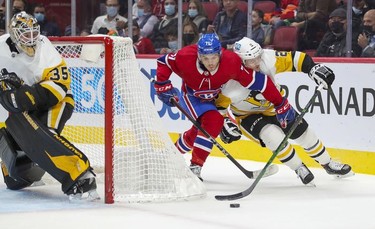 Montreal Canadiens' Jake Evans tries to cut in front of Pittsburgh Penguins defenceman Chad Ruhwedel next to goalie Tristan Jarry during first period in Montreal Thursday, Nov. 18, 2021.