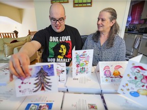 Zachary Reisman and his mother Lorri Benedik, partners in Zach Designs, with a variety of greeting cards that Zach illustrates, at their Pierrefonds home..