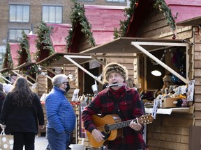 Mr. André performs traditional Québécois music as he entertains people at Christmas market in downtown Montreal on Sunday, Nov. 21, 2021.