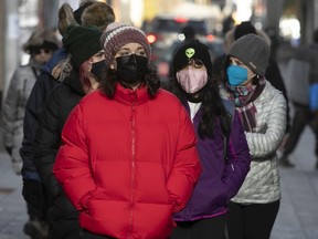 Pedestrians with masks on La Gauchetiere on Tuesday November 23, 2021.