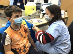 Alexander Pantopoulos gets vaccinated Wednesday Nov. 24, 2021 at the Palais des congrès.