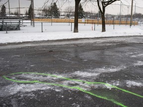 Police markings outline an area where blood stains were found at the scene of a stabbing in Marc-Aurèle-Fortin Park in Laval on Jan. 2, 2020.
