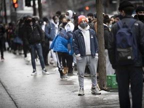 Montreal shoppers stand in line for Black Friday sales on Ste- Catherine on Friday November 27, 2020.