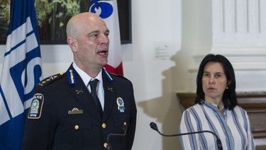 Mayor Valérie Plante listens as SPVM deputy chief Vincent Richer speaks at a news conference in Montreal Monday, November 29, 2021 to announce a forum on armed violence.