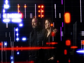 Eyal Weizman, founder of Forensic Architecture, and filmmaker and journalist Laura Poitras with a display of digital data points in the Terror Contagion exhibition, on view starting Dec. 1 at the Musée d’art contemporain de Montréal’s temporary location in Place Ville Marie.