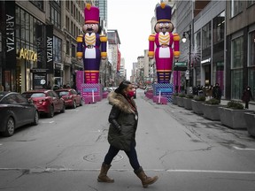 Shoppers cross Ste- Catherine St. during the Christmas shopping morning on Saturday Dec. 12, 2020.