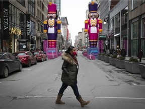 Shoppers cross Ste- Catherine St. on Saturday, Dec. 12, 2020.