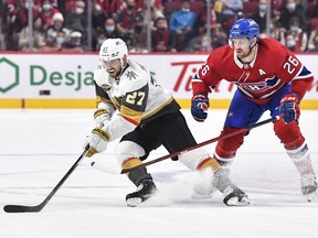 Shea Theodore (27) of the Vegas Golden Knights skates the puck against Canadiens' Jeff Petry during the first period at the Centre Bell on Saturday, Nov. 6, 2021, in Montreal.