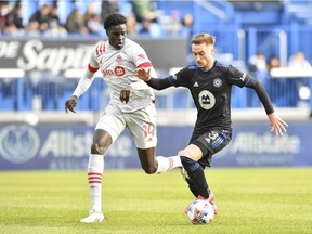 Djordje Mihailovic of CF Montréal controls the ball against Noble Okello of Toronto FC in the first half during the 2021 Canadian Championship Final at Stade Saputo on Nov. 21, 2021, in Montreal.