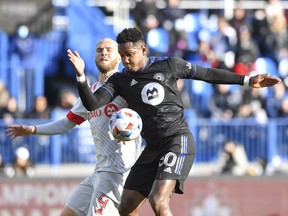 Toronto FC's Michael Bradley faces CF Montreal's Romell Quioto, up front, in the first half of the 2021 Canadian Championship game at Saputo Stadium on November 21, 2021, in Montreal.