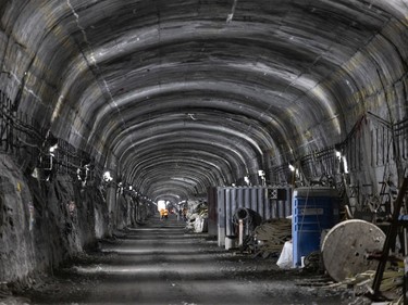Workers, in the distance, in the Mount Royal REM tunnel, at about 72 metres below the surface at the Édouard-Montpetit station on Wednesday, Nov. 24, 2021.
