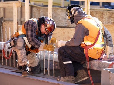 A welder and a fitter weld rebar to the steel structure at the Édouard-Montpetit station of the REM on Nov. 24, 2021.