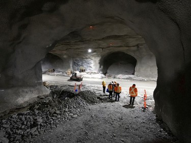 Members of the media are dwarfed by the Mount Royal REM tunnel, at about 72 metres below the surface at the Édouard-Montpetit station on Wednesday, Nov. 24, 2021.