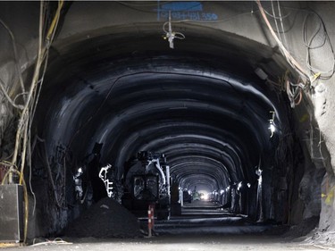 Workers, in the distance, in the Mount Royal REM tunnel, at about 72 metres below the surface at the Édouard-Montpetit station on Wednesday, Nov. 24, 2021.