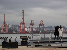 Shipping cranes sit idle at the Port of Vancouver Nov. 20, 2021, after flooding in B.C. Widespread flooding, landslides and road washouts have halted railway access to the Port of Vancouver.