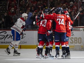 Capitals players celebrate after scoring first-period goal while the Canadiens’ Cédric Paquette skates past during game Wednesday night in Washington. Capitals won the game 6-3.