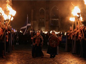 Boys dressed as Vikings join the men leading a torchlight procession in Edinburgh, Scotland, in 2011.