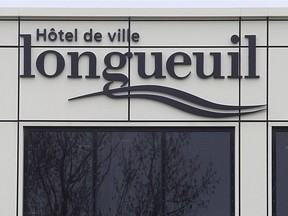 A sign on a building indicates it is Longueuil city hall