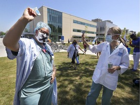 Health-care workers demonstrate outside Maisonneuve-Rosemont Hospital in Montreal on May 27, 2020.