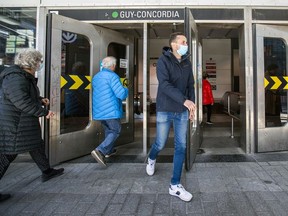 Mask-wearing transit users pass through the doors of the Guy-Concordia Metro station on Guy St. during continuing pandemic in Montreal Wednesday April 7, 2021. (John Mahoney / MONTREAL GAZETTE) ORG XMIT: 51318 - 5964