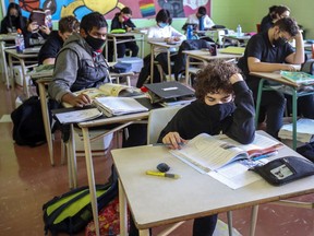 Masked students read at their desks at John F. Kennedy High School in Montreal Tuesday November 10, 2020. Even though masks are no longer mandatory for students seated in classrooms, Fariha Naqvi-Mohamed says she is thankful that many are still choosing to wear them.