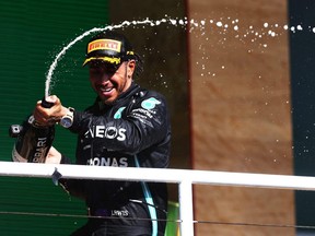 Race winner Lewis Hamilton celebrates on the podium during the F1 Grand Prix of Brazil at Autodromo Jose Carlos Pace in Sao Paulo, Brazil, on Sunday, Nov. 14, 2021.