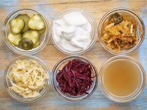 Many fermented foods are sources of probiotics. From top left: cucumber pickles, coconut milk yogurt and kimchi. From bottom left: sauerkraut, red beets and apple cider vinegar.