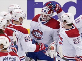 Canadiens goaltender Jake Allen celebrates with teammates after a win over the Pittsburgh Penguins in Pittsburgh on Saturday, Nov. 27, 2021.