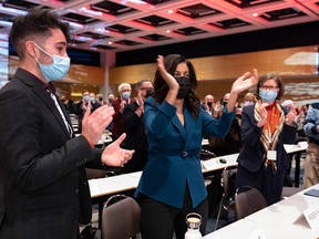 Quebec Liberal Leader Dominique Anglade, centre, joins the applauding delegates as she enters the Quebec Liberal members convention on Friday, Nov. 26, 2021, in Quebec City.