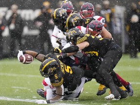 Hamilton Tiger-Cats running back Don Jackson (5) lunges across the goal line as he scores a touchdown during first half CFL division semi-final football action against the Montreal Alouettes in Hamilton, Ont., on Sunday, November 28, 2021.