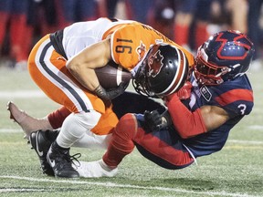 Alouettes' Patrick Levels brings down B.C. Lions' Bryan Burnham during second half in Montreal on Sept. 18, 2021.