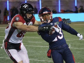 Alouettes' Martese Jackson tries to get past Redblacks' Kenny Stafford during a kick return in the first quarter Friday night at Molson Stadium.