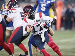 Alouettes quarterback Trevor Harris (17) is tackled from behind against the Blue Bombers at IG Field in Winnipeg on Saturday, Nov. 6, 2021.