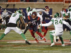 Alouettes tailback William Stanback carries the ball against Saskatchewan Roughriders' A.C. Leonard (6) and Damon Webb during the second quarter at Molson Stadium in Montreal on Oct. 30, 2021.