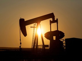 An oil pump jack pumps in a field near Calgary.