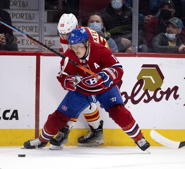 Montreal Canadiens right wing Brendan Gallagher  holds up Calgary Flames defenseman Oliver Kylington in first-period action on Thursday, Nov. 11, 2021.